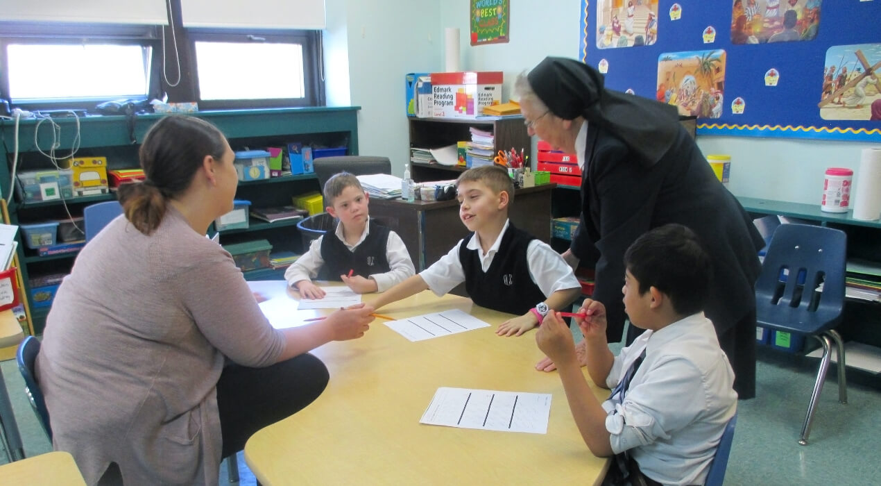 Small children learning around a table