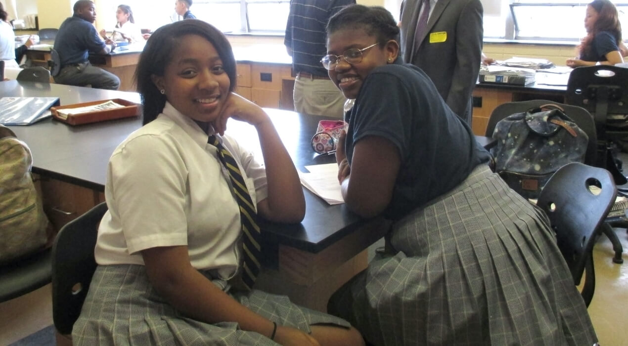 Two girls smiling during lunch